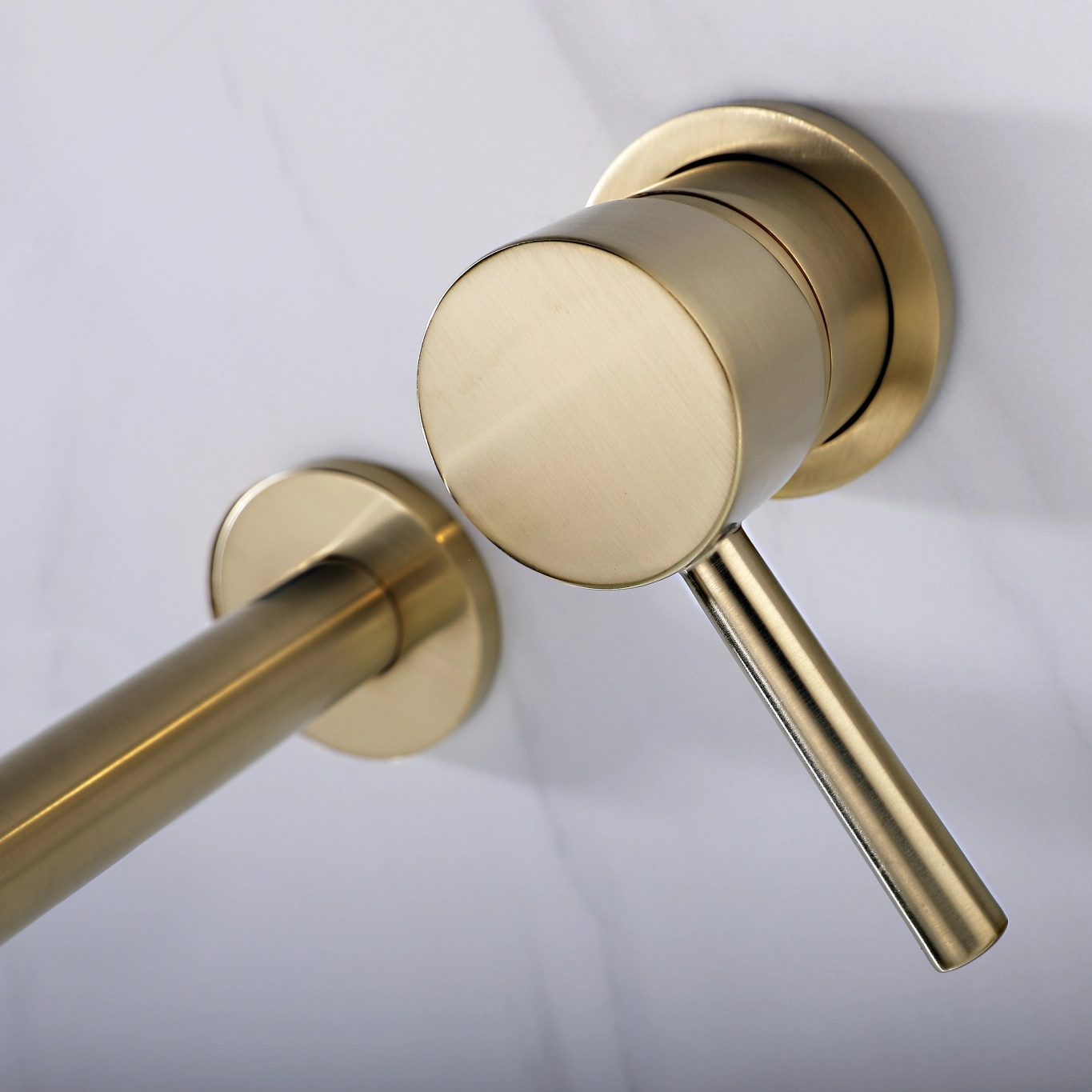 Brushed gold wall mounted basin mixer